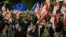 Protesters wave flags during a pro-Europe rally in Tbilisi on October 20, ahead of the parliamentary elections.