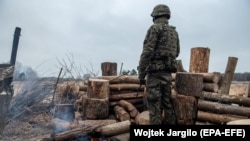 A Polish soldier keeps watch on the Belarusian border with Poland, which has come under increasing migratory pressure in recent months. 