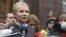 Former Ukrainian Prime Minister Yulia Tymoshenko talks to the media as she arrives at the state prosecutor's office in Kyiv on December 15