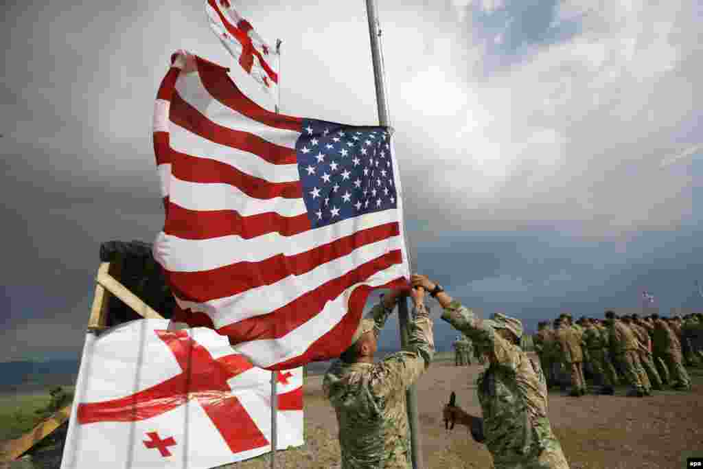 Georgian soldiers adjust the U.S. national flag during joint military exercises at a military base outside Tbilisi on May 24. (epa/Zurab Kurtsikidze)