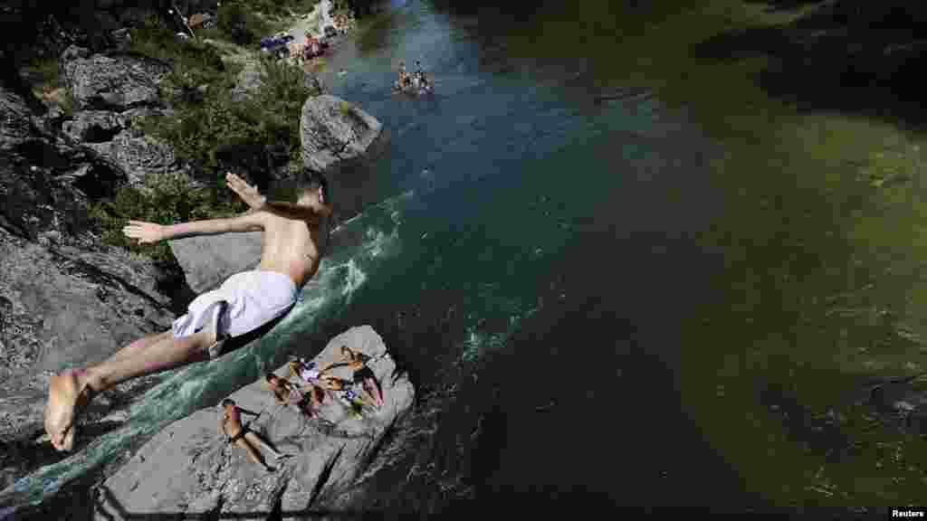 A boy dives into the Treska River for a swim as temperatures soared to 43 degrees Celsius near the Macedonian capital, Skopje. (Reuters/Ognen Teofilovski&nbsp;)