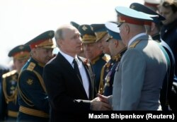 Putin welcomes guests during the Victory Day parade.