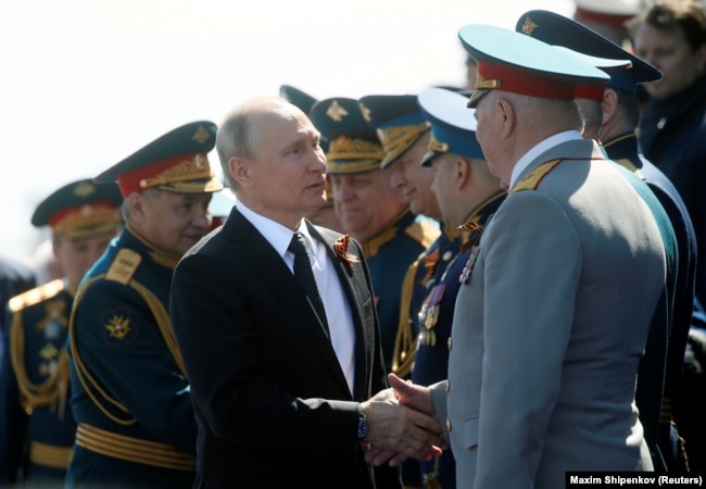 Putin welcomes guests during the Victory Day parade.