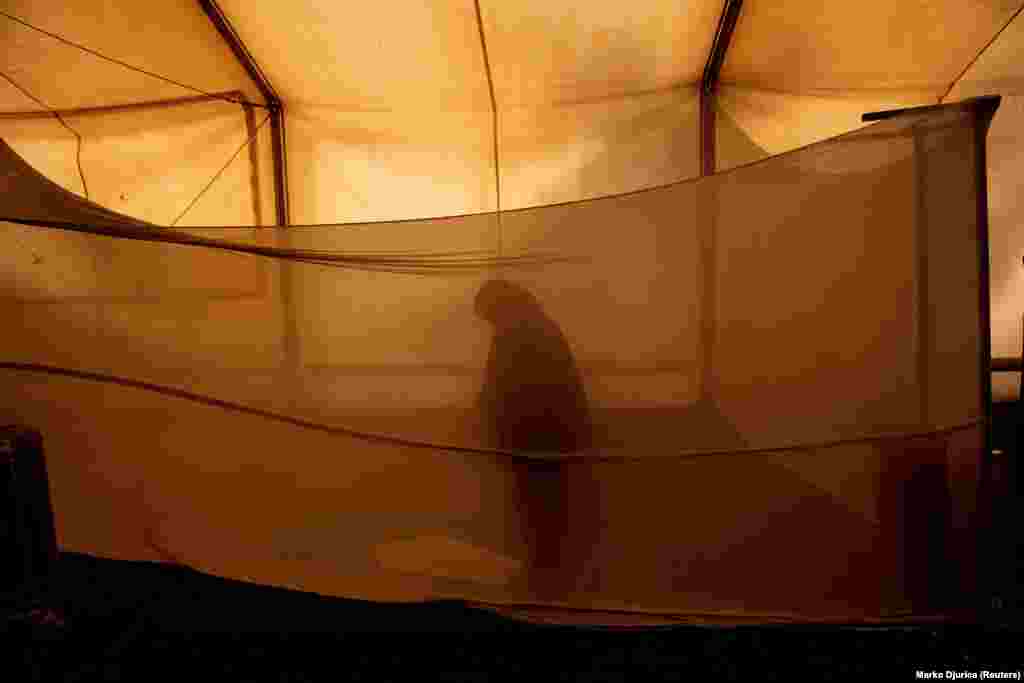 A migrant prays in a makeshift mosque inside the Sid-Point camp in Sid, Serbia. (Reuters/Marko Djunca)