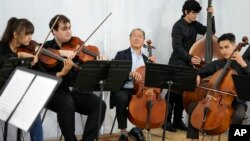 U.S. cellist Yo-Yo Ma plays with young Afghan and Portuguese musicians at Portugal's National Conservatory in Lisbon on March 29.