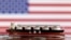 Një model i një anijeje-cisternë për transportin e LNG-së shihet përpara flamurit amerikan në këtë ilustrim, të realizuar më 19 maj 2022.
