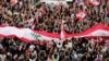 Anti-government protesters shout slogans in Beirut, Lebanon, Sunday, Oct. 20, 2019. Tens of thousands of Lebanese protesters of all ages gathered Sunday in major cities and towns nationwide, October 20, 2019