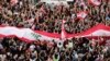 Anti-government protesters shout slogans in Beirut, Lebanon, Sunday, Oct. 20, 2019. Tens of thousands of Lebanese protesters of all ages gathered Sunday in major cities and towns nationwide, October 20, 2019