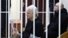 Nobel Peace Prize laureate Ales Byalyatski, who co-founded the Viasna human rights group, and his co-workers Valiantsin Stefanovich and Uladzimir Labkovich attend a court hearing in Minsk