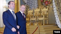 Russian President Dmitry Medvedev (left) and Prime Minister and President-elect Vladimir Putin walk after taking part in the State Council session at the Kremlin in Moscow on April 24.