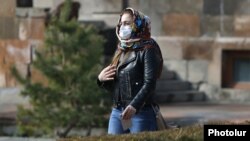 Armenia -- A woman wears a medical mask in Yerevan, March 1, 2020.