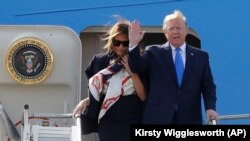 President Donald Trump waves and he and first lady Melania Trump arrive at Stansted Airport in England, Monday, June 3, 2019 at the start of a three day state visit to Britain.