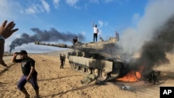 Палестинци върху горящ израелски танк
