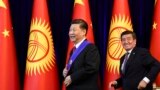 Chinese President Xi Jinping (left) and Kyrgyz President Sooronbai Jeenbekov leave after a joint news conference on the sidelines of the Shanghai Cooperation Organization summit in Bishkek in June 2019.