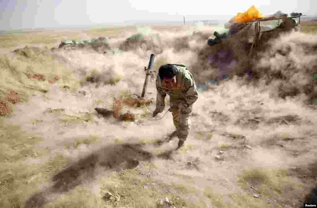 A Kurdish Peshmerga fighter launches mortar shells toward Zummar, which is controlled by Islamic State (IS) fighters, near Mosul in northern Iraq. (Reuters/Ahmed Jadallah)