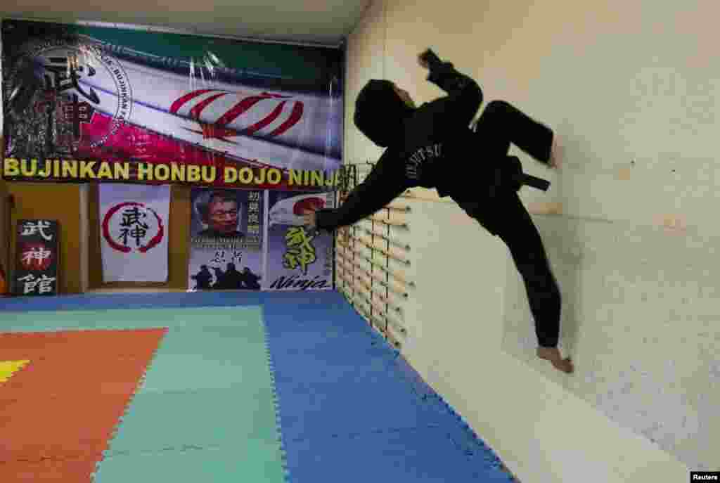 A ninjutsu practitioner runs up a wall.