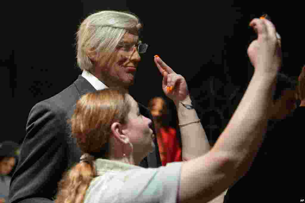 A women takes a selfie with a sculpture of US President Donald Trump at a wax museum in St. Petersburg, Russia.