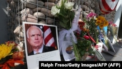 Flowers and personal items outside Senator John McCain's office in Phoenix as people pay their respects to the late Arizona senator.