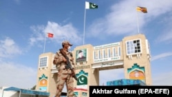 FILE: A Pakistani soldier stands guard at the border crossing between Afghanistan and Pakistan in Chaman.