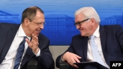 Russian Foreign Minister Sergei Lavrov (left) and German counterpart Frank-Walter Steinmeier laugh ahead of a panel discussion of the 52nd Munich Security Conference in Munich in February.