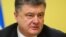 Ukrainian President Petro Poroshenko has signed into law legislation granting special status to areas of eastern Ukraine under rebel control.
