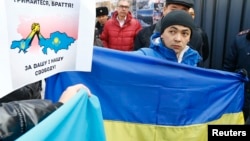 Kazakhs protest outside the Consulate-General of Russia in Almaty on March 3, supporting Ukraine "for your and our freedom." 