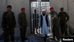 A newly freed prisoner emerges after a ceremony handing over the Bagram prison to Afghan authorities, at the U.S. airbase in Bagram in March 2013.