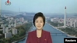 News reader announces the launch of a working satellite to mark the 100th birthday of Kim Il-sung in Pyongyang.