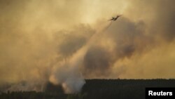 A plane drops water as Ukrainian firefighters fight a fire in the vicinity of Chernobyl in 2015.