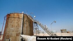 IRAQ -- A worker checks a tank in Zubair oilfield in Basra, Iraq August 9, 2017.