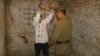 Сцена допроса заключенного Карлага под пытками, показываемая сотрудниками музея Карлага. Поселок Долинка Карагандинской области, 19 мая 2013 года. 