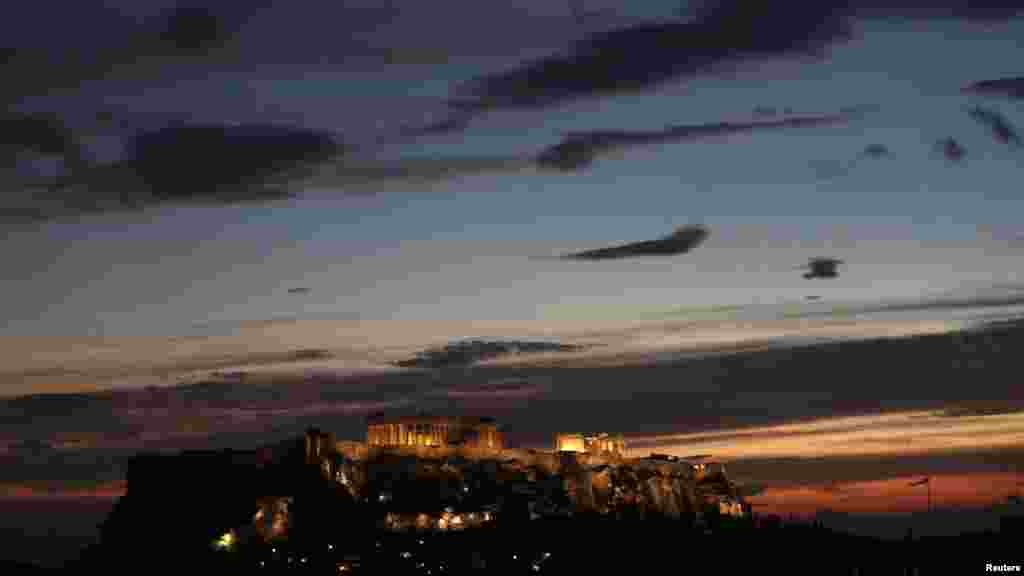 The temple of the Parthenon is illuminated at the Acropolis hill in Athens. (Reuters/John Kolesidis)