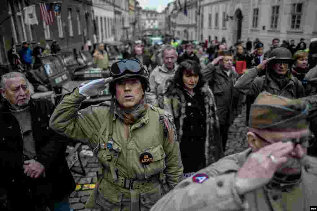 History enthusiasts wearing WWII U.S. Army uniforms salute as the national anthem of the United States is played during the Convoy Of Liberty commemoration event in Prague. The Convoy Of Liberty commemorates the moments in 1945 when the western part of the country was liberated from Nazi oppression by the U.S. Army. (epa/Martin Divisek)