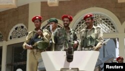 Military policemen stood guard outside a ministry building in Sanaa in early June.