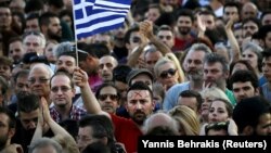 A protester sports the word "no" in Greek on his forehead as he waves a Greek flag during an antiausterity demonstration in Syntagma Square in Athens on July 3.