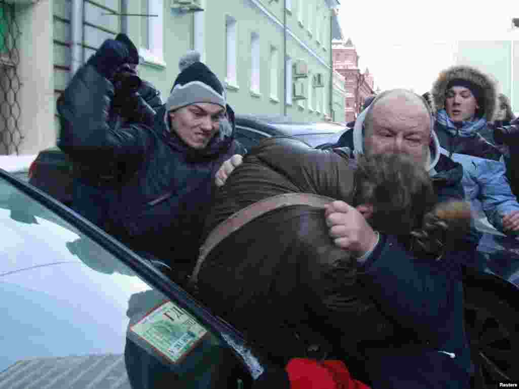 Unknown assailants attack a gay-rights activist during a protest outside the State Duma in Moscow. The State Duma is to consider a federal bill that makes the dissemination of information about Russia's gay community to minors punishable by fines of up to $16,000. (Reuters/Sergei Karpukhin)