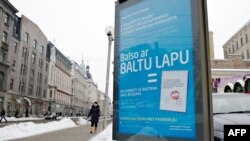 Latvia -- An advertisement board reads "Vote with white list and add your wish", Riga, 14Feb2012