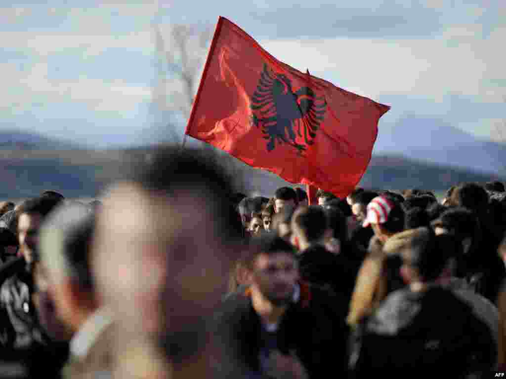 Ethnic Albanians wave an Albanian flag during an electoral rally in Mitrovica, in northern Kosovo. Photo by AFP