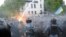 Ukraine - Supporters of nationalist parties throw a lit flare into ranks of riot police during a protest in Lviv during Victory day marking the anniversary of the end of WWII, 09May2011