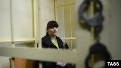 Jailed opposition activist Taisia Osipova behind bars in a courtroom in Smolensk in August 2012