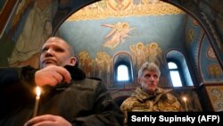 War veterans attend a church service commemorating the defenders of the Donetsk airport in the eastern Ukrainian conflict with Russia-backed separatists.