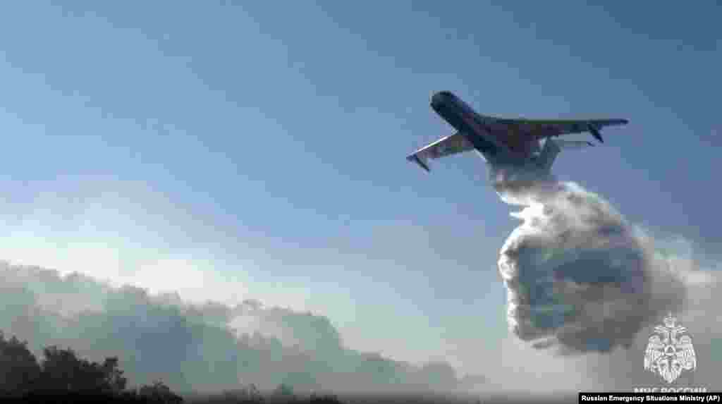 Another&nbsp;Beriev Be-200 aircraft drops its load of water.