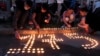 RUSSIA - People place lit candles on the ground to form the number 175 after a shooting at school No.175 in Kazan, Russia, Tuesday, May 11, 2021