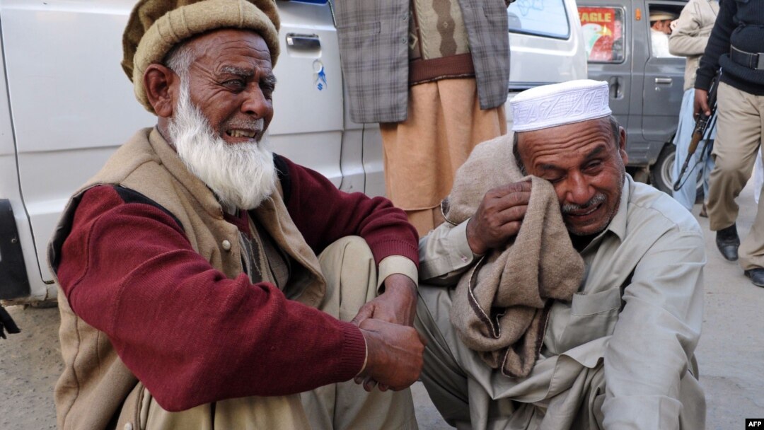 Men react after learning that their relatives were among those killed in the bomb blast in Nowshera. 