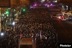 Armenian opposition supporters take part in a torchlight procession in Yerevan on December 18.