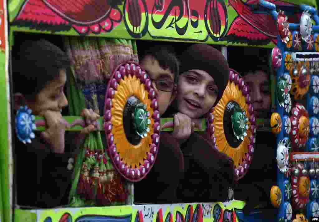 Pakistani children travel to school in Peshawar, where schools reopened on January 12 for the first time since Taliban gunmen massacred 150 people, mainly children, at a school in the city. (AFP/A Majeed)