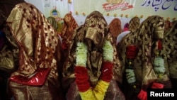 Brides sit together during a mass wedding ceremony in Peshawar. (file photo)