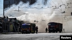Firefighters work at the site of a recent Russian missile strike in Zaporizhzhya.