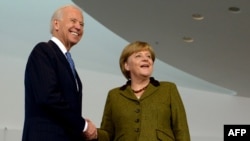 German Chancellor Angela Merkel (right) welcomes U.S. Vice President Joe Biden at the Chancellery in Berlin on February 1.