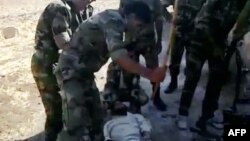 A video shows what is described by antiregime activists as the torture by government forces of a "martyr" named Louai al-Amer in Houla in Homs last year.